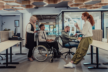 Image showing Young group of business people brainstorming together in a startup space, discussing business projects, investments, and solving challenges.