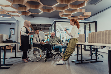 Image showing Young group of business people brainstorming together in a startup space, discussing business projects, investments, and solving challenges.