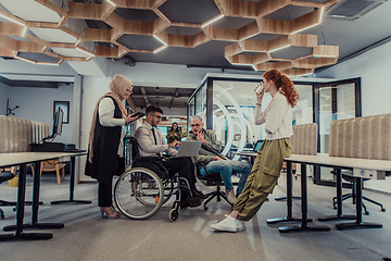 Image showing Young group of business people brainstorming together in a startup space, discussing business projects, investments, and solving challenges.