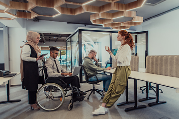 Image showing Young group of business people brainstorming together in a startup space, discussing business projects, investments, and solving challenges.