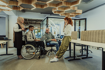 Image showing Young group of business people brainstorming together in a startup space, discussing business projects, investments, and solving challenges.