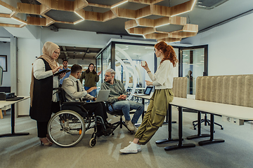 Image showing Young group of business people brainstorming together in a startup space, discussing business projects, investments, and solving challenges.