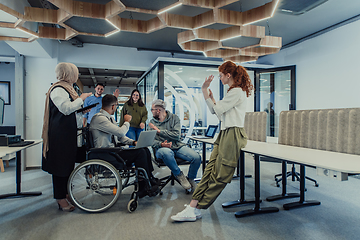 Image showing Young group of business people brainstorming together in a startup space, discussing business projects, investments, and solving challenges.