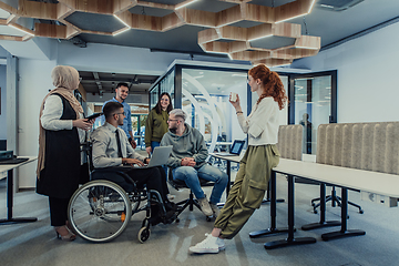 Image showing Young group of business people brainstorming together in a startup space, discussing business projects, investments, and solving challenges.