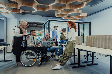 Image showing Young group of business people brainstorming together in a startup space, discussing business projects, investments, and solving challenges.