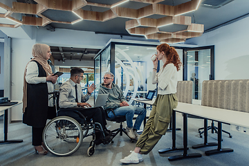 Image showing Young group of business people brainstorming together in a startup space, discussing business projects, investments, and solving challenges.