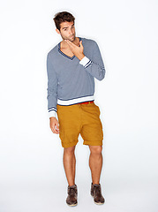 Image showing Handsome, portrait and a man with fashion on a white background for style, trendy and cool. Unique, stylish and a confident guy or model with clothes, shorts or casual clothing on a studio backdrop