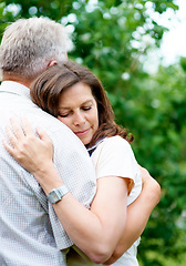 Image showing Senior couple, support and eyes closed with hug, marriage and embrace in outdoor, trust and retired. Retirement, elderly and love in park, bonding and care for romantic relationship, man and woman