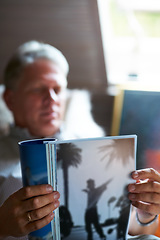 Image showing Relax, magazine or mature man reading newspaper articles in home for information or story updates. Blur, book or senior person studying abstract art for knowledge in a publication in living room