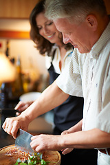 Image showing Mature couple, cooking together and healthy food, love and marriage with fresh vegetables in home. Meal prep, old man and happy woman in kitchen with support, diet and salad for dinner in apartment.