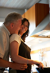 Image showing Mature couple, embrace and cooking together with food, love and marriage at stove in home for lunch. Happiness, old man and woman in kitchen with hug, smile and meal prep for dinner in apartment.