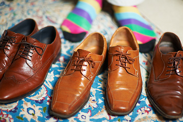 Image showing Man getting ready, shoes and socks with choice on carpet in home, putting on business fashion or start to day. Businessman dressing for work in morning, feet on floor with style and wardrobe decision