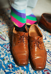 Image showing Man getting ready, shoes and socks in home, putting on business fashion on foot and start to day. Businessman dressing for work in morning, feet on hotel room floor with style and wardrobe on carpet.