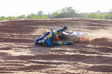 Image showing Sand, accident and motorbike for sports with action for challenge or competition with power. Speed, mistake and desert with bike for race or adventure in outdoor with freedom or fearless driving.