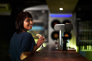 Image showing Woman, smile and drink in portrait at bar, face and happy at event, party or social gathering. Female person, alcohol and cocktail for fun, relax and travel to Ibiza, dark and joy at night on face
