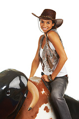 Image showing Woman, sitting and mechanical bull for cowboy in happy fashion portrait for western aesthetic in studio mockup. Cowgirl workout, athlete or smile face for wellness, health and exercise in texas sport