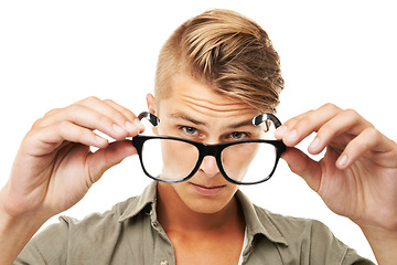 Image showing Perspective, portrait and a man with glasses on a white background for vision, eye care or test. Fashion, face and a person showing eyewear for lens, frame or optometry exam on a studio backdrop