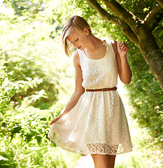 Image showing Summer, walking and forest with woman, sunshine and thinking with fun, fresh air and wellness. Person, outdoor and girl in the woods, park or trees with sunlight, carefree or dress with joy or nature