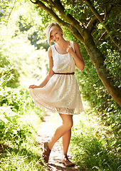 Image showing Summer, walking and forest with woman, portrait or happiness with fun, fresh air or smile. Person, outdoor or girl in the woods, park or trees with sunlight, carefree or dress with nature or wellness