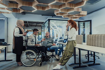 Image showing Young group of business people brainstorming together in a startup space, discussing business projects, investments, and solving challenges.