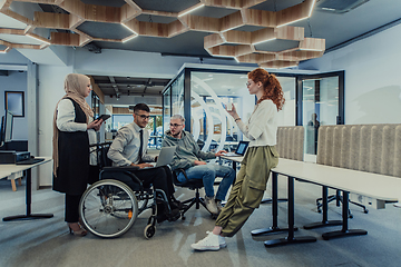 Image showing Young group of business people brainstorming together in a startup space, discussing business projects, investments, and solving challenges.