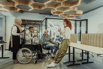 Image showing Young group of business people brainstorming together in a startup space, discussing business projects, investments, and solving challenges.