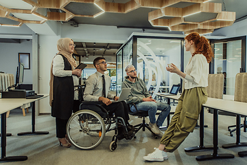 Image showing Young group of business people brainstorming together in a startup space, discussing business projects, investments, and solving challenges.