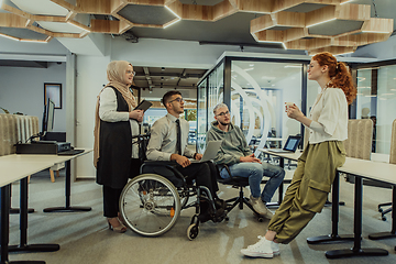 Image showing Young group of business people brainstorming together in a startup space, discussing business projects, investments, and solving challenges.