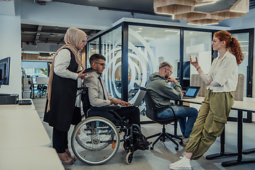 Image showing Young group of business people brainstorming together in a startup space, discussing business projects, investments, and solving challenges.