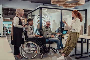 Image showing Young group of business people brainstorming together in a startup space, discussing business projects, investments, and solving challenges.