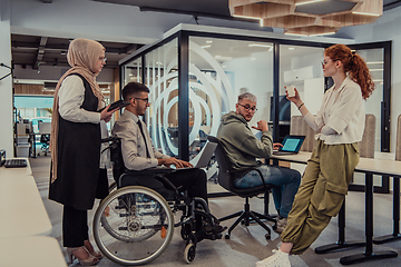 Image showing Young group of business people brainstorming together in a startup space, discussing business projects, investments, and solving challenges.