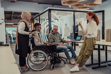 Image showing Young group of business people brainstorming together in a startup space, discussing business projects, investments, and solving challenges.