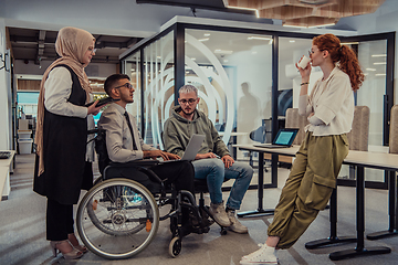 Image showing Young group of business people brainstorming together in a startup space, discussing business projects, investments, and solving challenges.