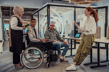 Image showing Young group of business people brainstorming together in a startup space, discussing business projects, investments, and solving challenges.