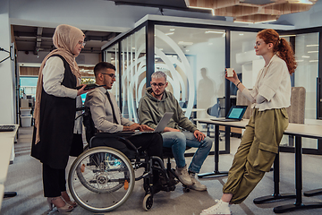 Image showing Young group of business people brainstorming together in a startup space, discussing business projects, investments, and solving challenges.