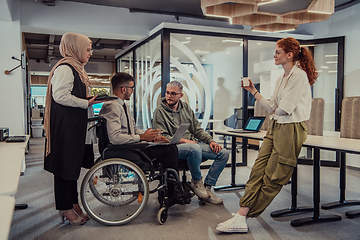 Image showing Young group of business people brainstorming together in a startup space, discussing business projects, investments, and solving challenges.