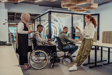 Image showing Young group of business people brainstorming together in a startup space, discussing business projects, investments, and solving challenges.