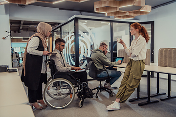 Image showing Young group of business people brainstorming together in a startup space, discussing business projects, investments, and solving challenges.