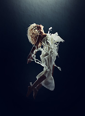 Image showing Art, dance and a ballet woman floating underwater for creative expression or theater performance. Freedom, energy and stage with a young person training for a show or rehearsal on a black background