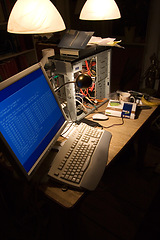 Image showing Computer hardware, cables or information technology on desk, code or programming in dark room. Desktop, pc and motherboard with mouse for data glitch, broken and metal parts for repair at home office