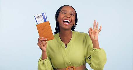 Image showing Black woman, passport and ok sign for studio portrait with airplane ticket, documents and excited by blue background. Girl, paperwork and emoji for compliance, immigration and international travel