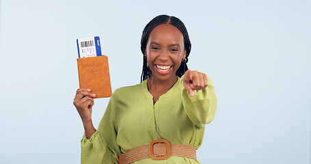 Image showing African woman, passport and studio portrait to point at you for airplane ticket, document and smile by blue background. Girl, paperwork and emoji for compliance, immigration and international travel
