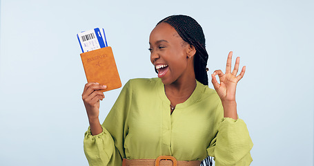 Image showing African woman, passport and studio with ok sign for airplane ticket, documents or excited smile by blue background. Girl, legal paperwork and emoji for compliance, immigration or international travel