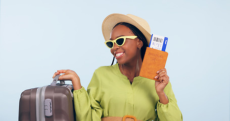 Image showing Happy African woman, passport and studio with suitcase, airplane ticket and documents by blue background. Girl, legal paperwork and luggage for compliance, vacation and sunglasses for global travel