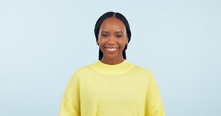 Image showing Portrait, young black woman and smile in studio with confidence, good mood or casual fashion isolated on blue background. Happy gen z model with cheerful personality, pride or mockup space in Nigeria