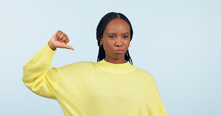 Image showing Thumbs down, portrait and hands of woman in studio for rejection of bad news, complaint and no feedback on blue background. African model show emoji sign for review of wrong decision, icon or failure