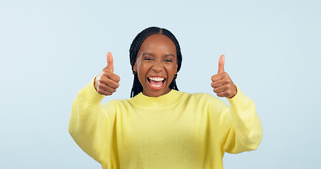 Image showing Portrait, smile and black woman with thumbs up, support and decision on a blue studio background. Face, African person and model with hand gesture, opportunity and feedback with review and emoji
