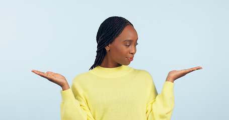 Image showing Black woman, palm and advertising in choice, decision or marketing against a studio background. African female person with hands out for selection, information or showing services on mockup space