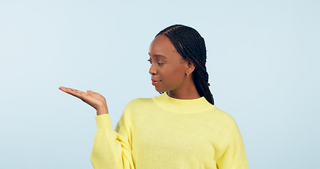 Image showing Woman, palm and advertising space in studio of announcement, mockup or promotion on blue background. African model show hand for presentation of choice, decision or feedback of deal, opinion or offer
