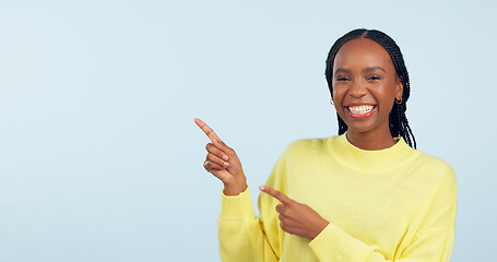 Image showing Pointing, portrait and black woman with opportunity, feedback and announcement on blue studio background. African person, model or girl with hand gesture, mockup space and decision with news or smile